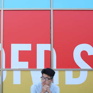 student in front of graphic design display